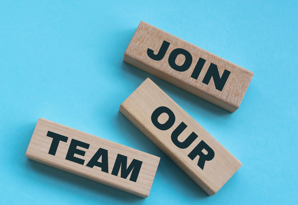 Brown blocks displaying the text 'join our team' on a blue background